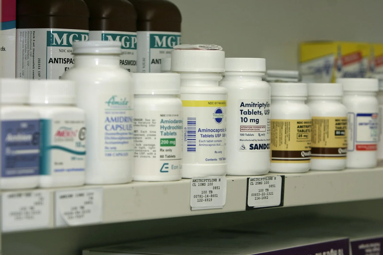 Pharmacy shelf stocked with medication bottles